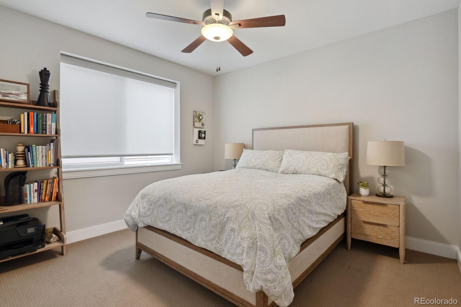 76 Niagara Street Denver, CO 80230 - Photo 18 of 44 a bedroom with a bed and a chandelier