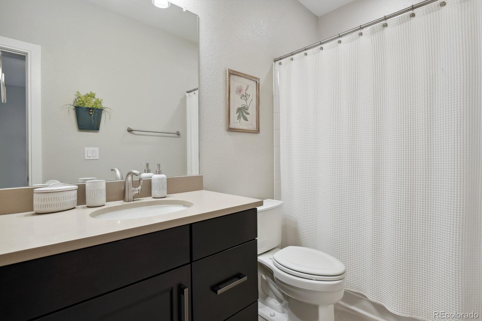 76 Niagara Street Denver, CO 80230 - Photo 19 of 44 a bathroom with a sink and a toilet