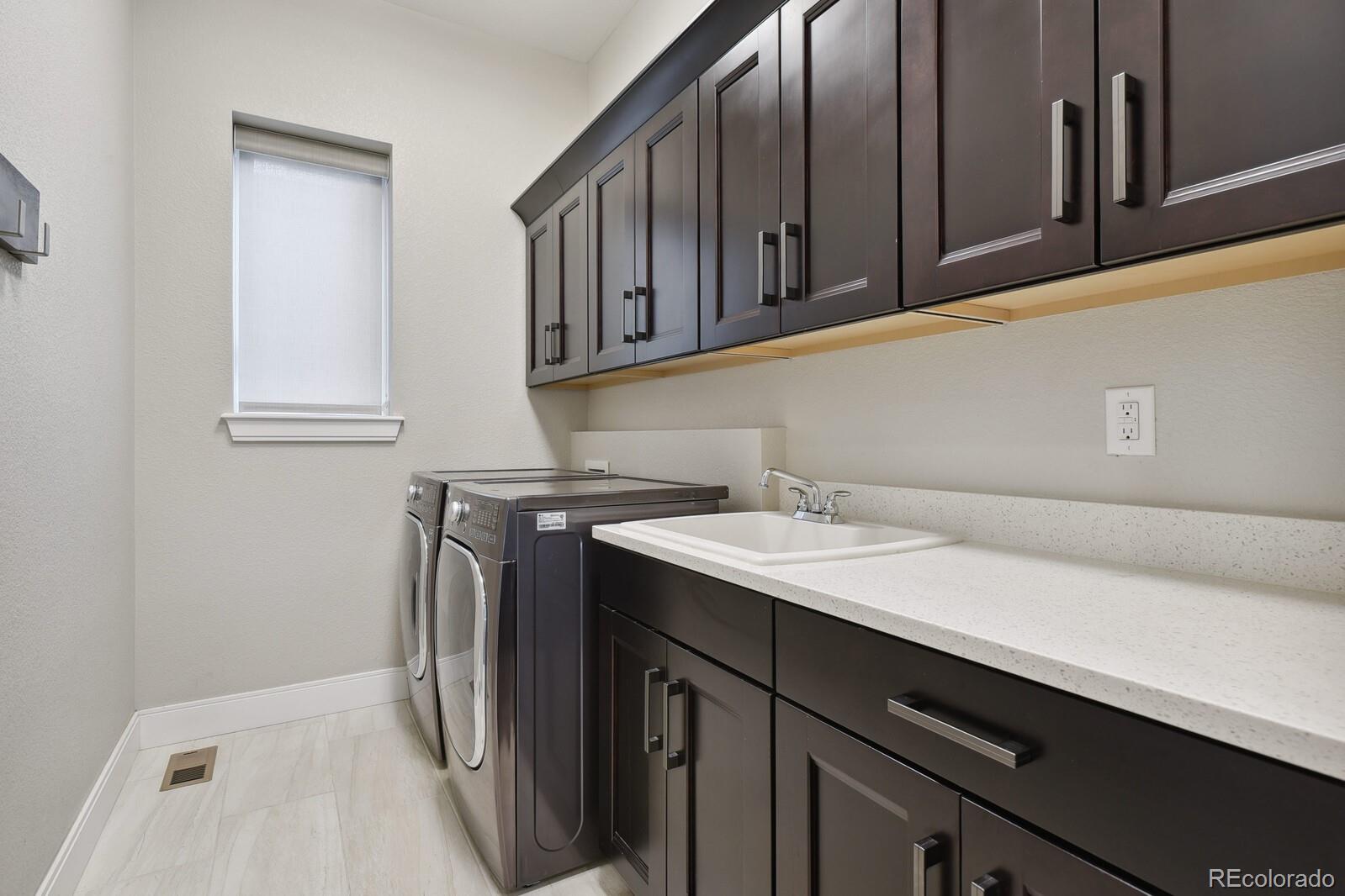 76 Niagara Street Denver, CO 80230 - Photo 22 of 44 a utility room with cabinets