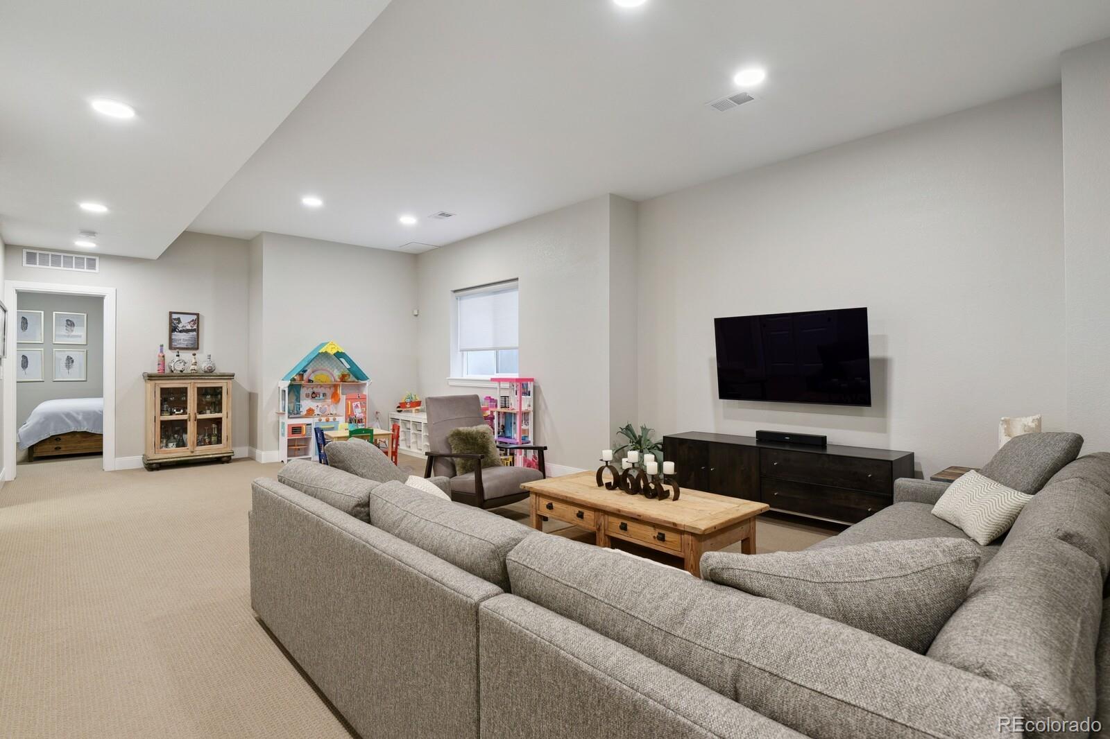 76 Niagara Street Denver, CO 80230 - Photo 24 of 44 a living room with furniture and a flat screen tv