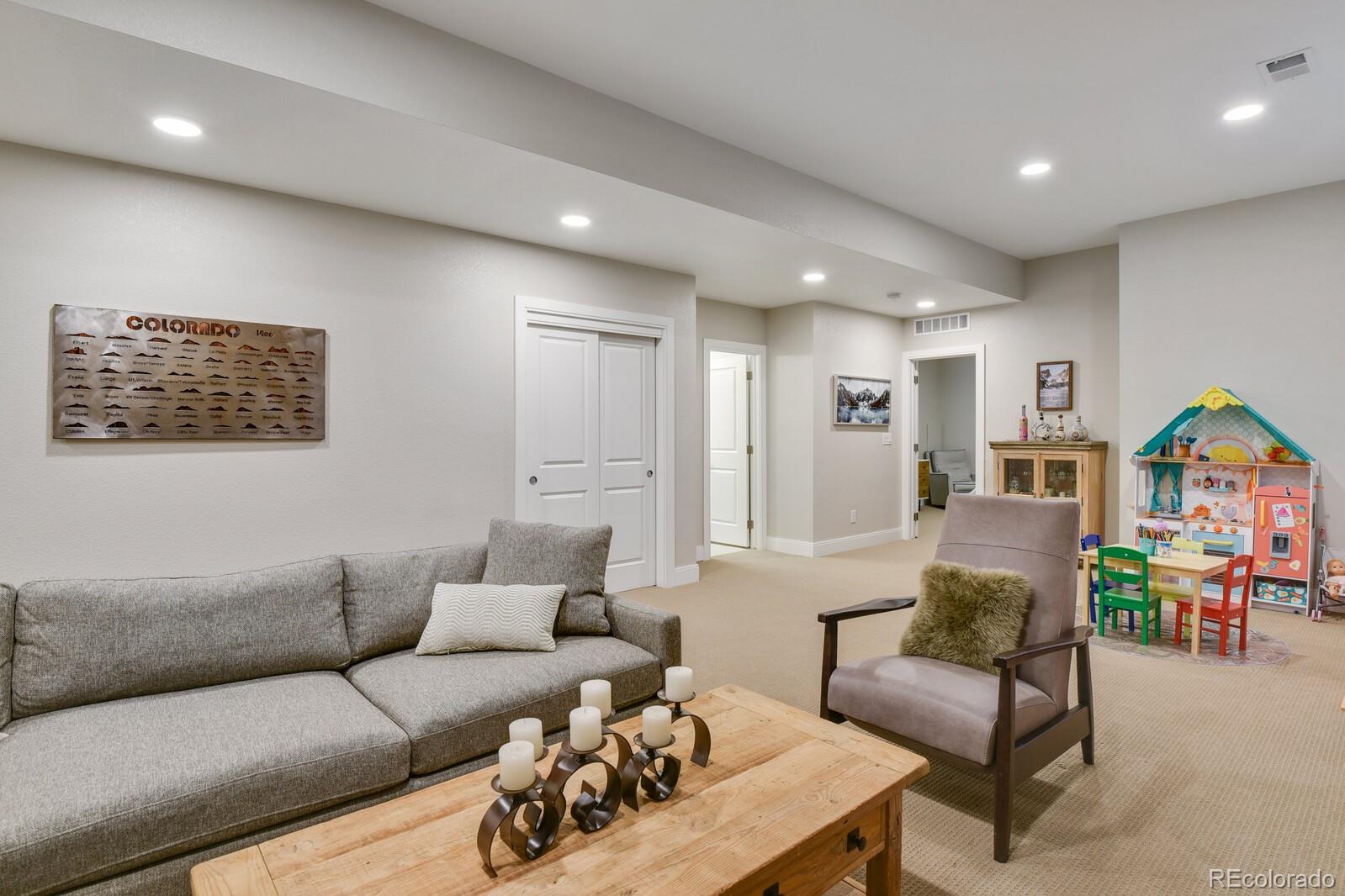 76 Niagara Street Denver, CO 80230 - Photo 26 of 44 a living room with furniture and a flat screen tv