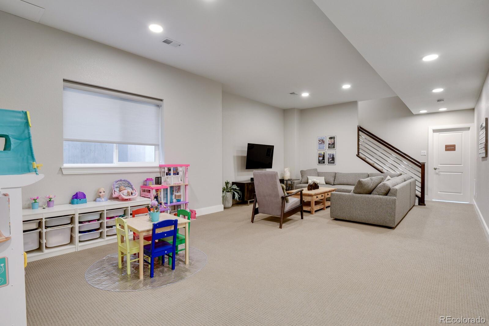 76 Niagara Street Denver, CO 80230 - Photo 27 of 44 a living room with furniture and a flat screen tv