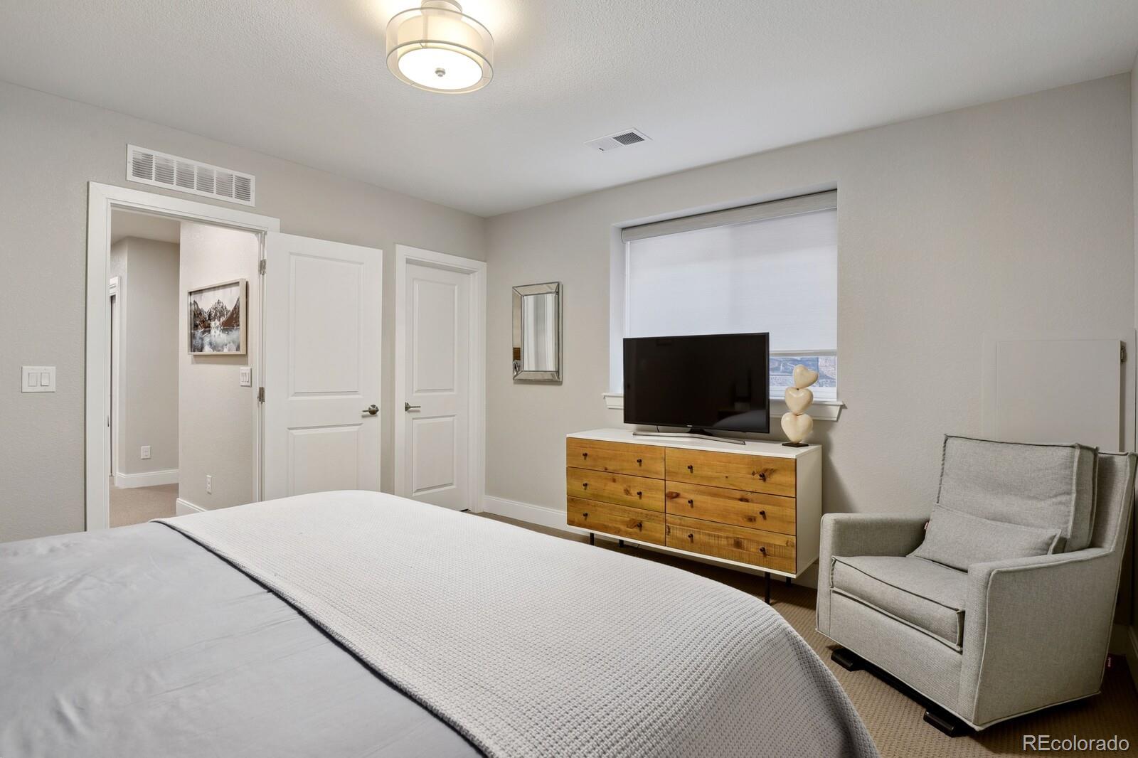 76 Niagara Street Denver, CO 80230 - Photo 29 of 44 a bedroom with a bed and a flat screen tv