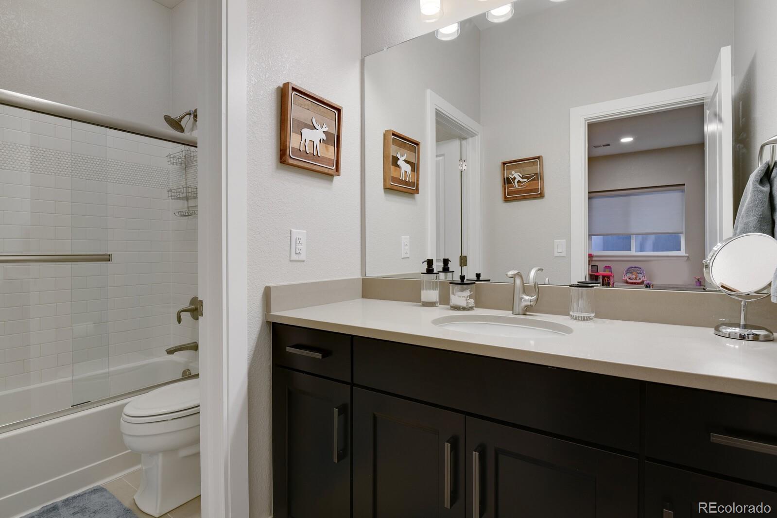 76 Niagara Street Denver, CO 80230 - Photo 30 of 44 a bathroom with a double vanity sink toilet and shower