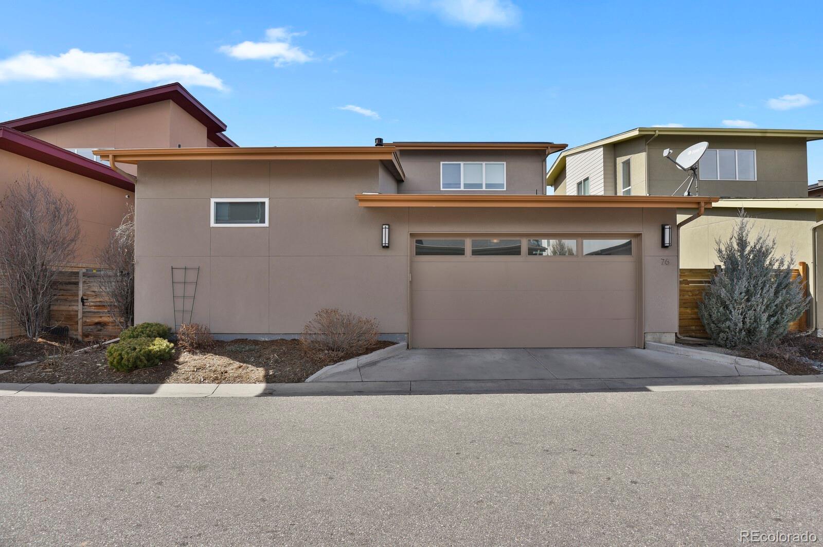 76 Niagara Street Denver, CO 80230 - Photo 36 of 44 a front view of a house with a yard and garage
