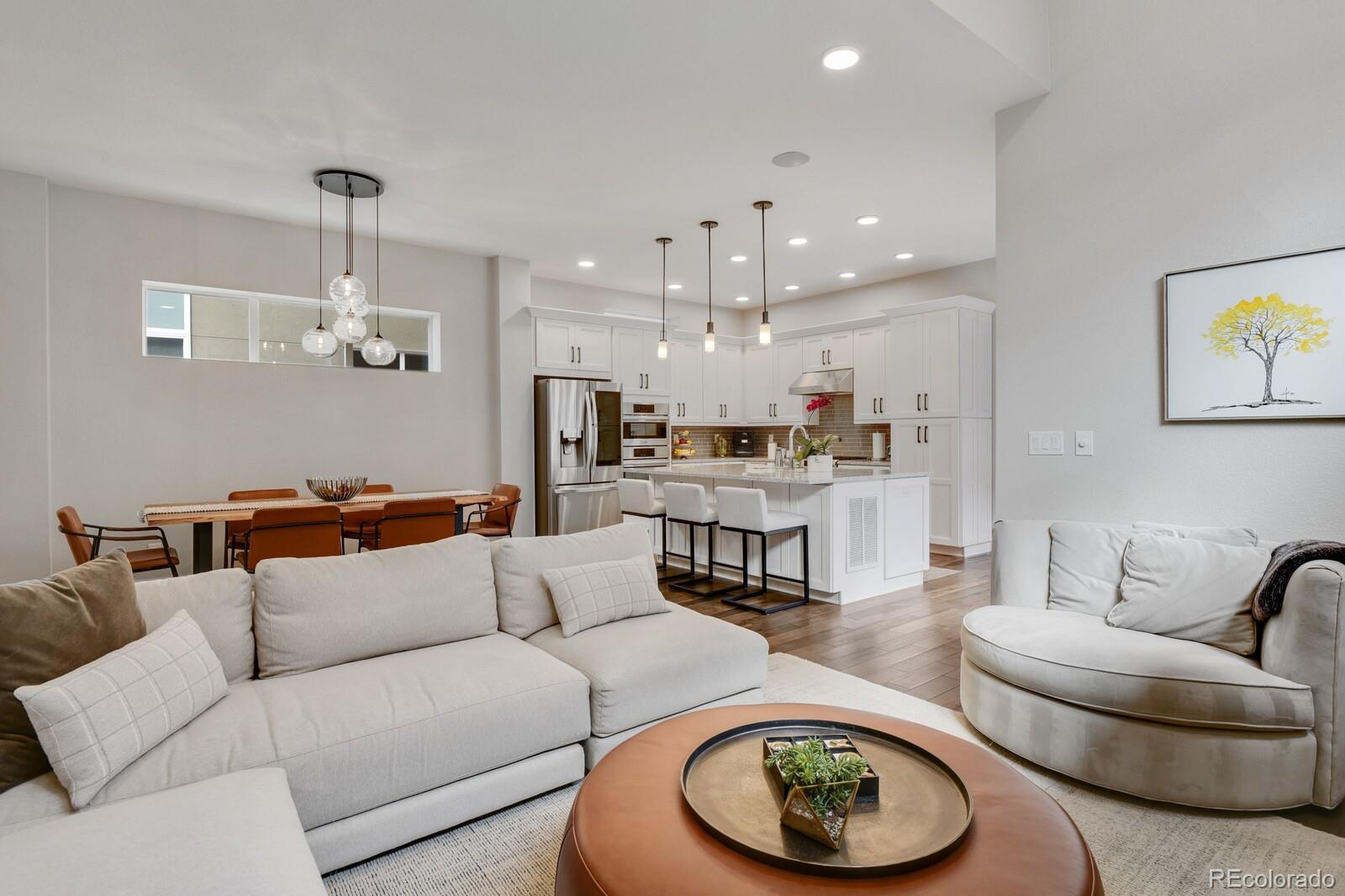 76 Niagara Street Denver, CO 80230 - Photo 4 of 44 a living room with furniture a rug and kitchen view