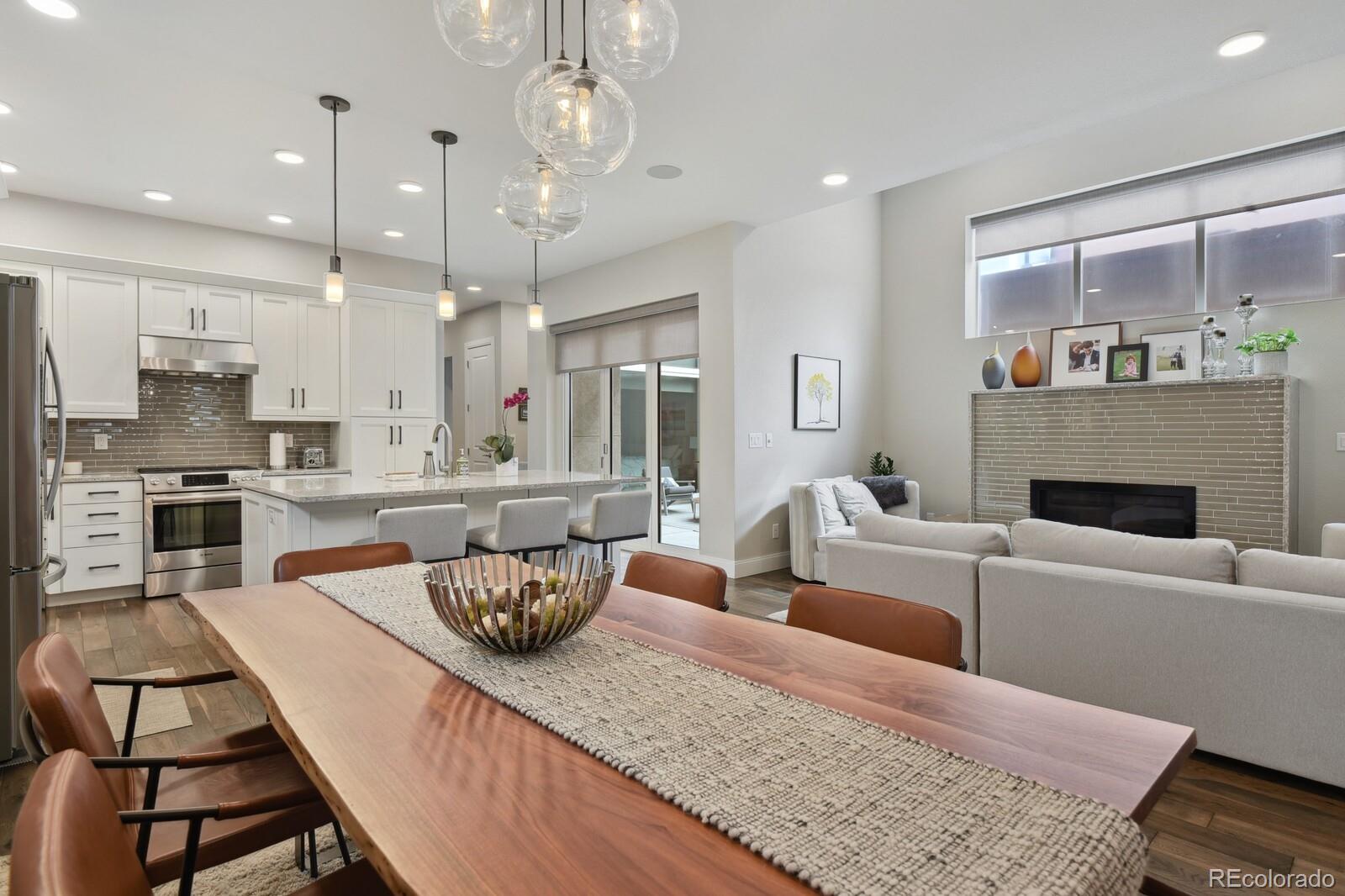 76 Niagara Street Denver, CO 80230 - Photo 5 of 44 a living room with fireplace furniture and a view of kitchen