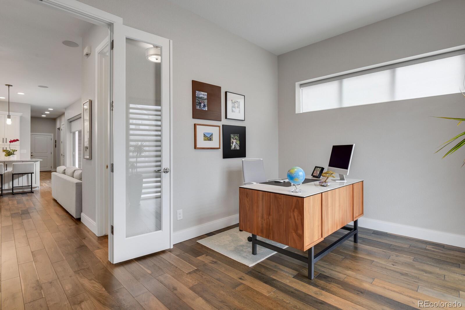 76 Niagara Street Denver, CO 80230 - Photo 10 of 44 a view of a workspace with wooden floor and windows
