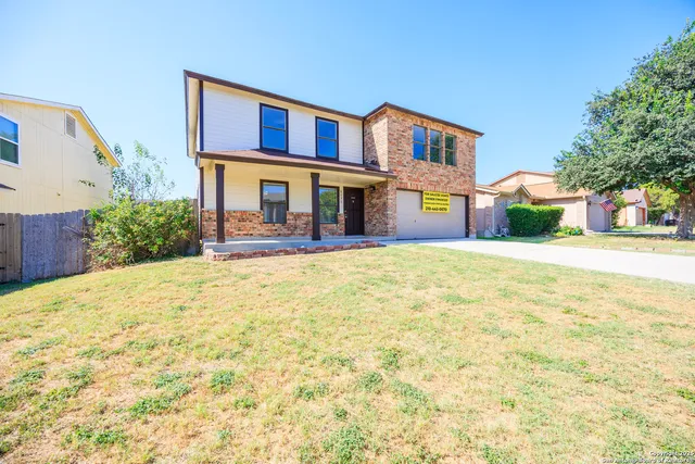 a front view of building with yard