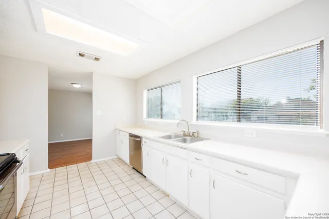a bathroom with a sink vanity granite tub and shower