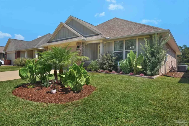 a view of a house with garden and yard