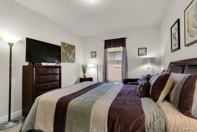 a bedroom with a bed and a flat screen tv