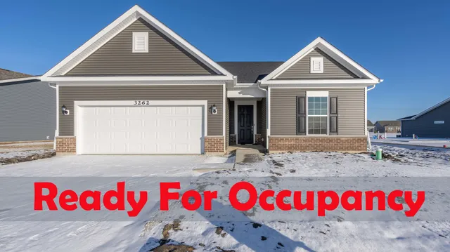 a living room with a fireplace and windows