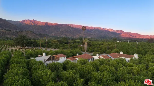 a view of a town with mountains in the background