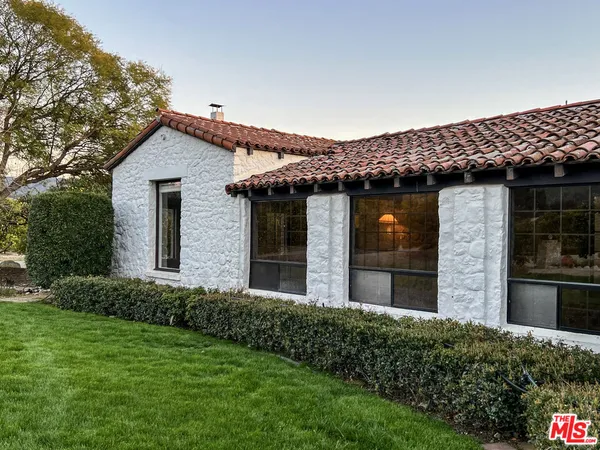 a view of a porch with wooden floor and a floor to ceiling window