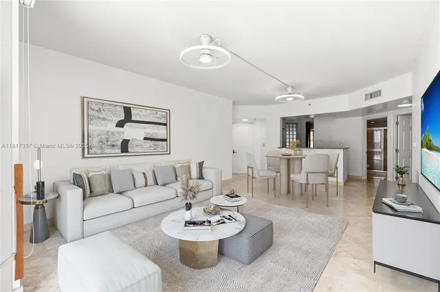 a living room with furniture and view of kitchen