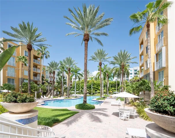 front view of house with a small yard and palm trees