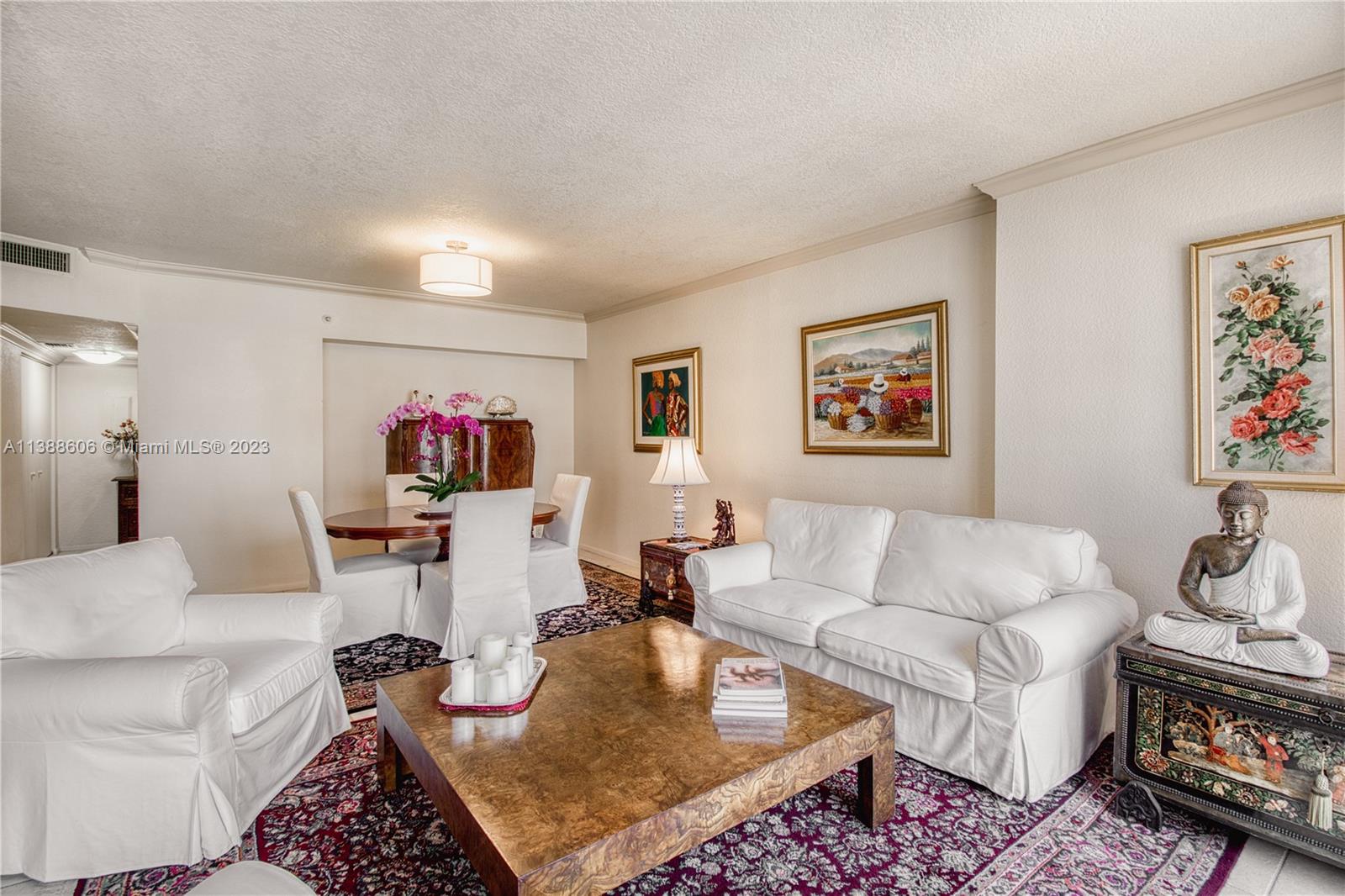 520 Brickell Key Drive, Unit A810 Miami, FL 33131 - Photo 12 of 20 a living room with furniture and a flat screen tv