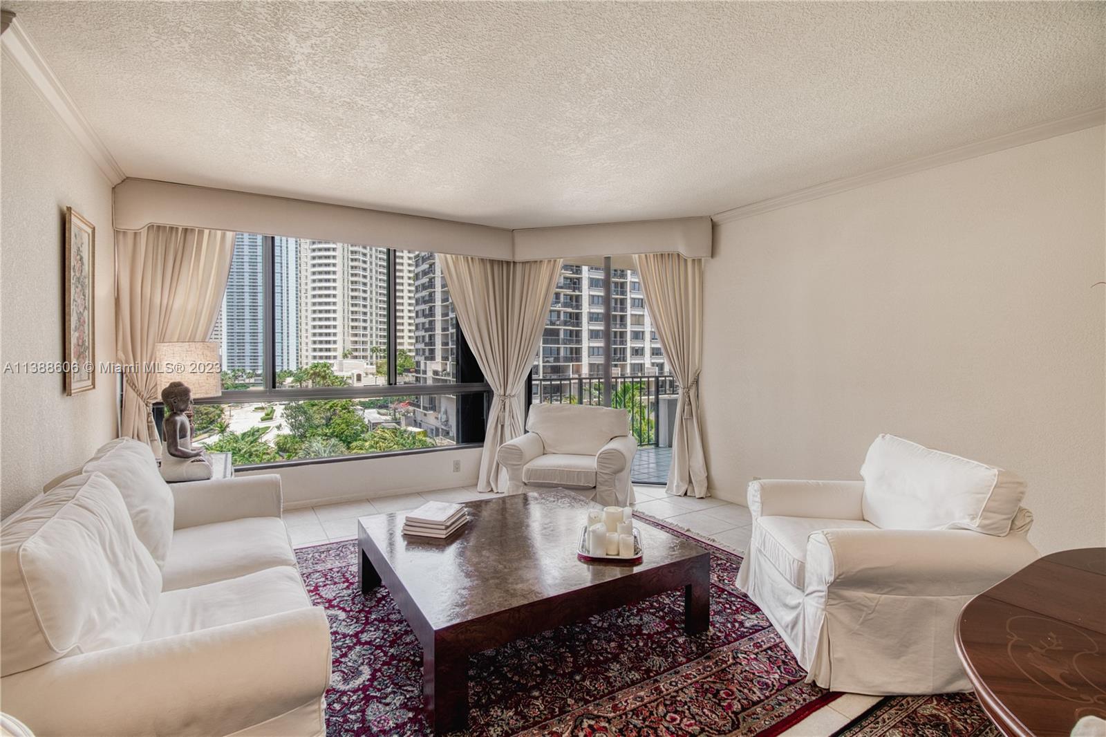 520 Brickell Key Drive, Unit A810 Miami, FL 33131 - Photo 13 of 20 a living room with furniture and a large window