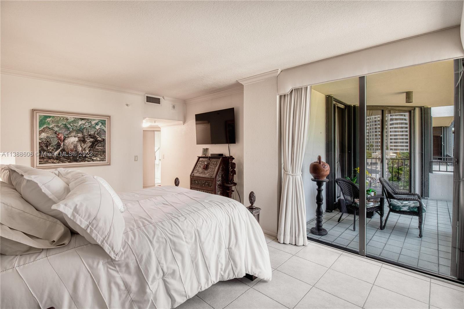 520 Brickell Key Drive, Unit A810 Miami, FL 33131 - Photo 15 of 20 a bed room with a bed and a television
