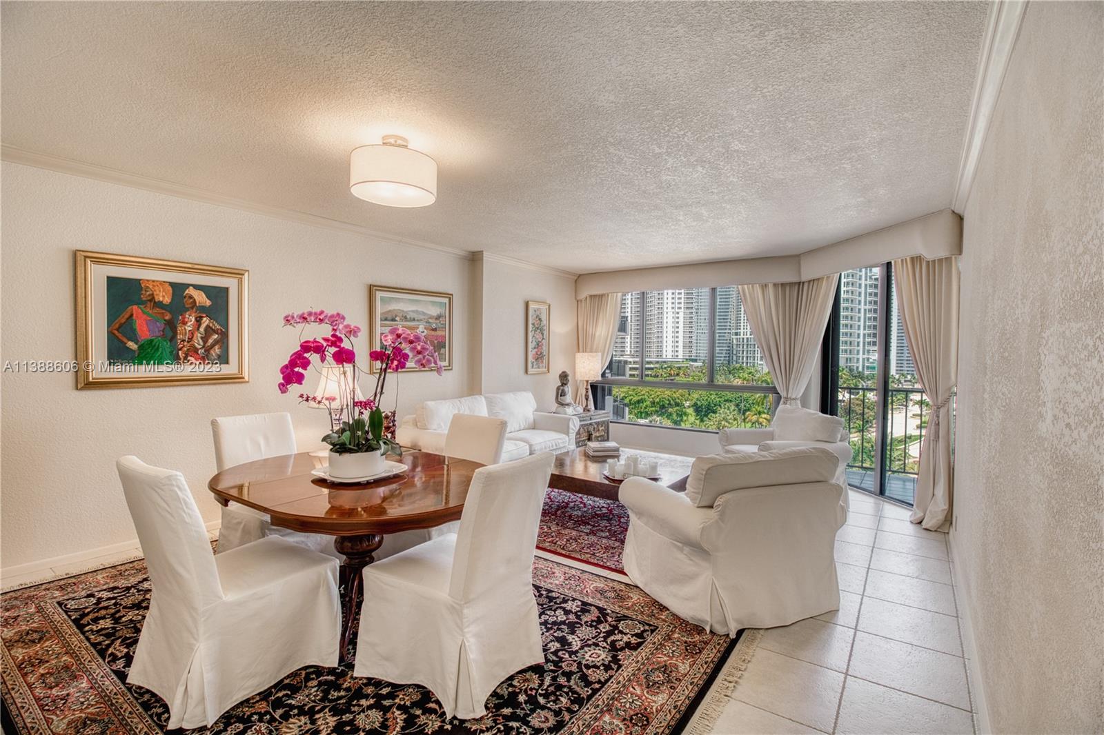520 Brickell Key Drive, Unit A810 Miami, FL 33131 - Photo 2 of 20 a dining room with furniture and a potted plant