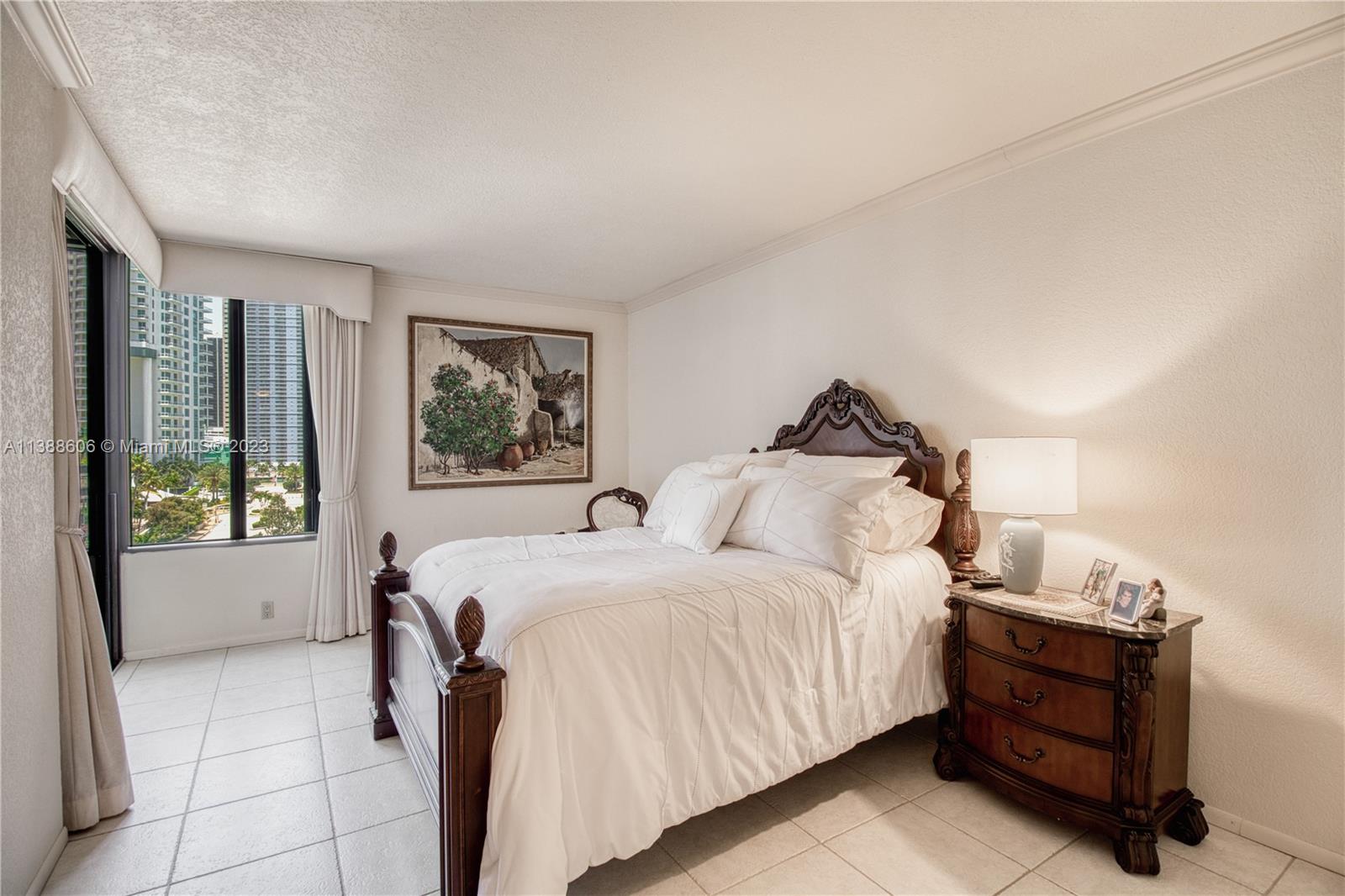 520 Brickell Key Drive, Unit A810 Miami, FL 33131 - Photo 4 of 20 a bedroom with a bed and wooden floor