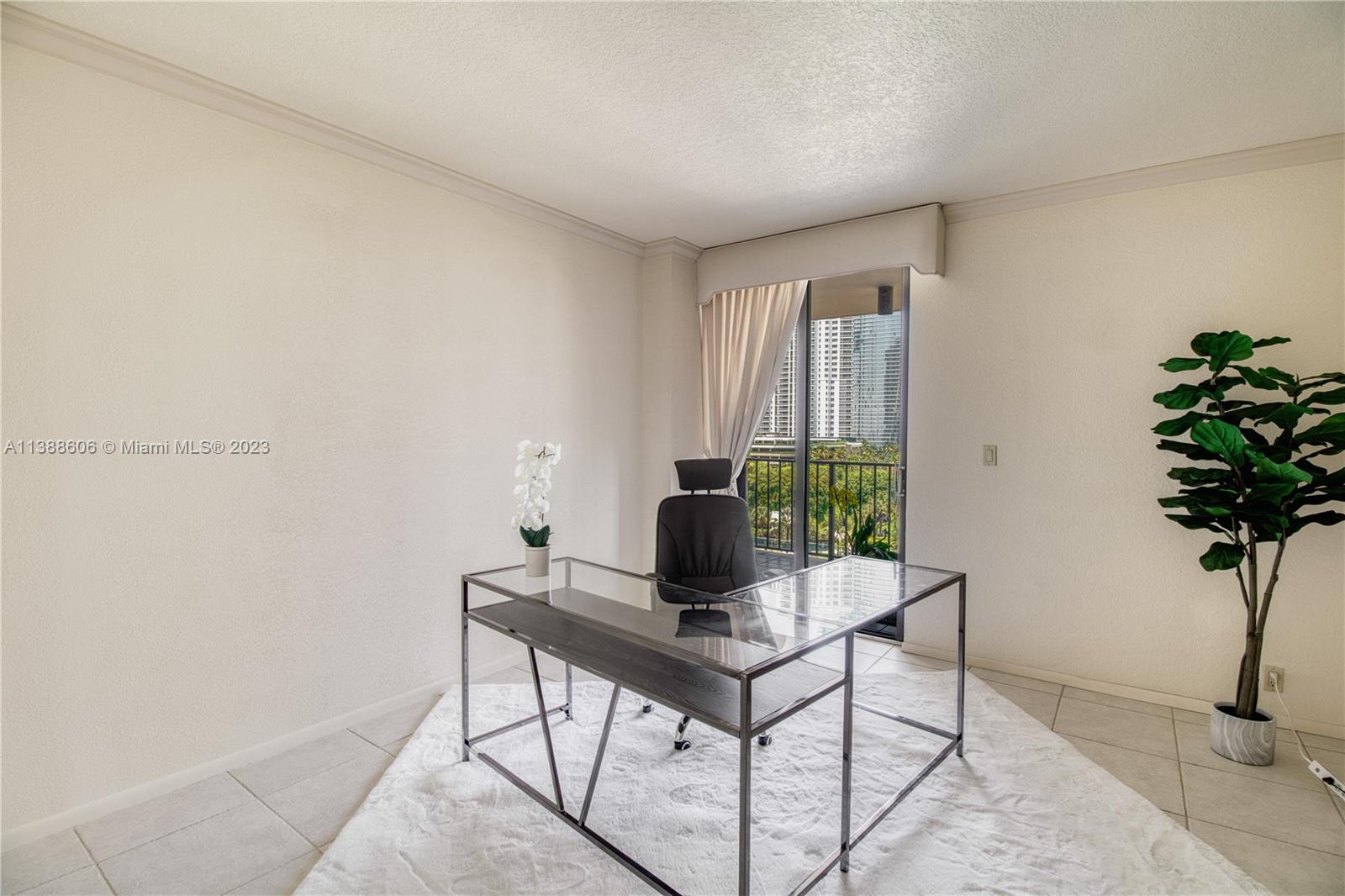 520 Brickell Key Drive, Unit A810 Miami, FL 33131 - Photo 5 of 20 a living room with furniture and a potted plant