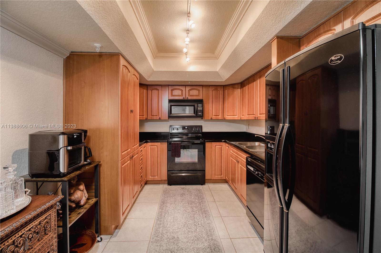 520 Brickell Key Drive, Unit A810 Miami, FL 33131 - Photo 8 of 20 a kitchen with stainless steel appliances granite countertop a refrigerator and a stove top oven
