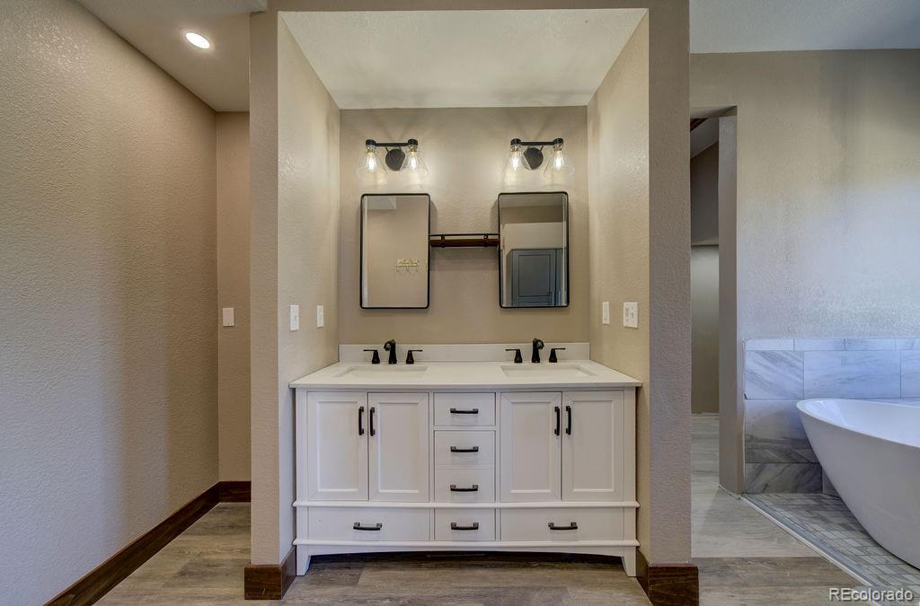 14965 Tanner Trail Elbert, CO 80106 - Photo 14 of 40 a bathroom with double sink and mirror