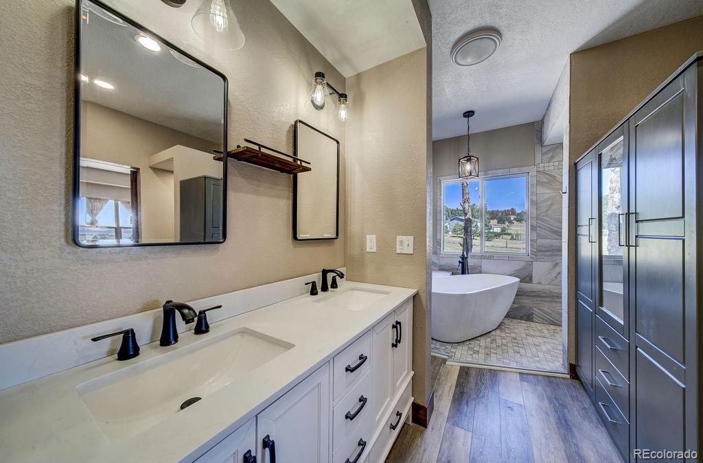 14965 Tanner Trail Elbert, CO 80106 - Photo 15 of 40 a bathroom with a double vanity sink mirror and bathtub