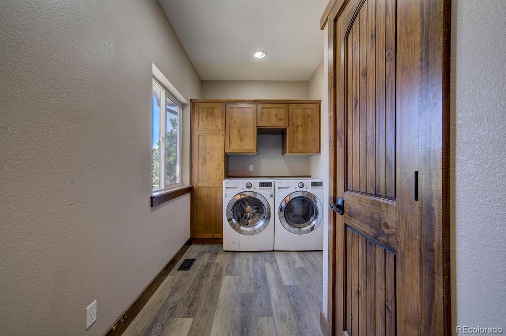 14965 Tanner Trail Elbert, CO 80106 - Photo 19 of 40 a view of a hallway with washer and dryer