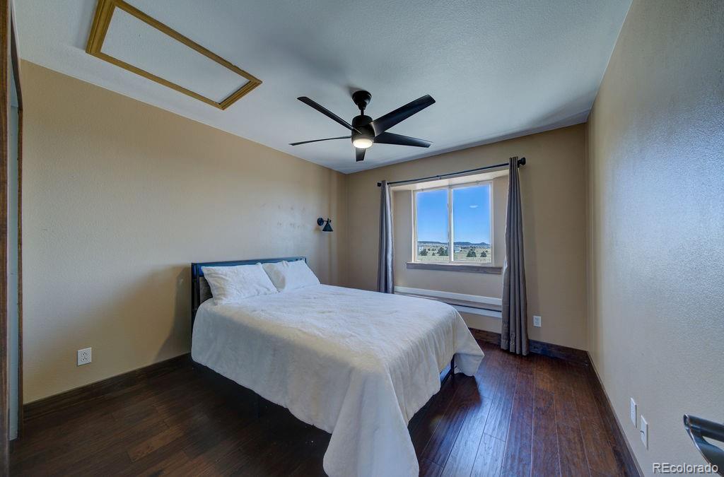 14965 Tanner Trail Elbert, CO 80106 - Photo 21 of 40 a bedroom with a bed and a large window