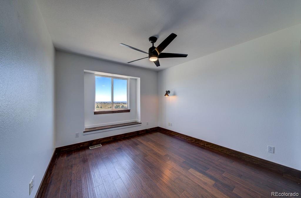 14965 Tanner Trail Elbert, CO 80106 - Photo 23 of 40 wooden floor in an empty room with a window
