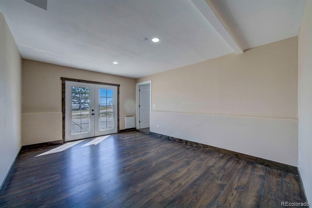 14965 Tanner Trail Elbert, CO 80106 - Photo 26 of 40 a view of an empty room with wooden floor