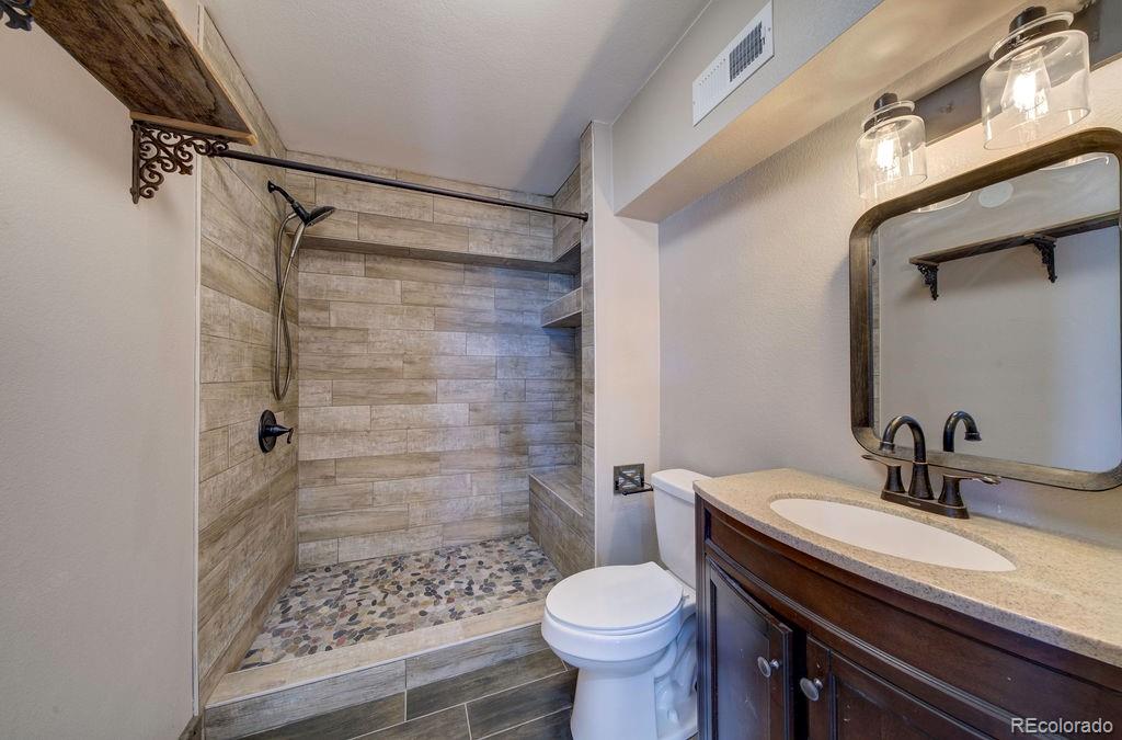 14965 Tanner Trail Elbert, CO 80106 - Photo 28 of 40 a bathroom with a sink toilet and shower