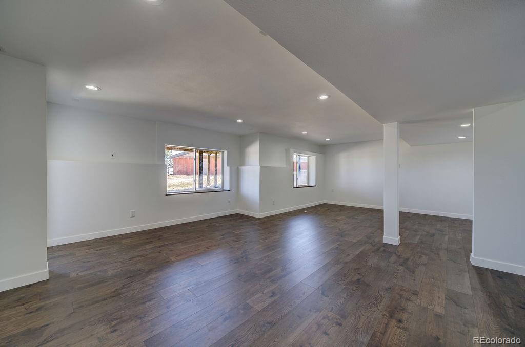 14965 Tanner Trail Elbert, CO 80106 - Photo 30 of 40 an empty room with wooden floor and windows