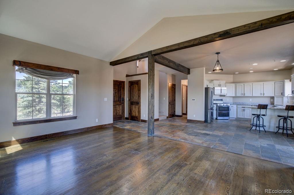14965 Tanner Trail Elbert, CO 80106 - Photo 6 of 40 an empty room with wooden floor and a window