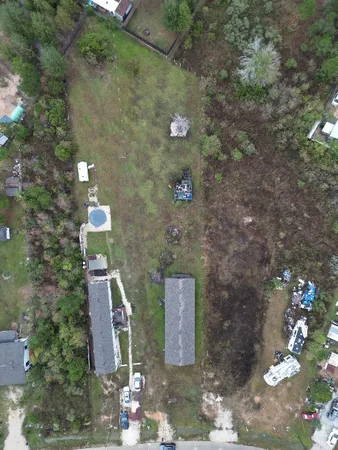 a aerial view of a house with lots of green space