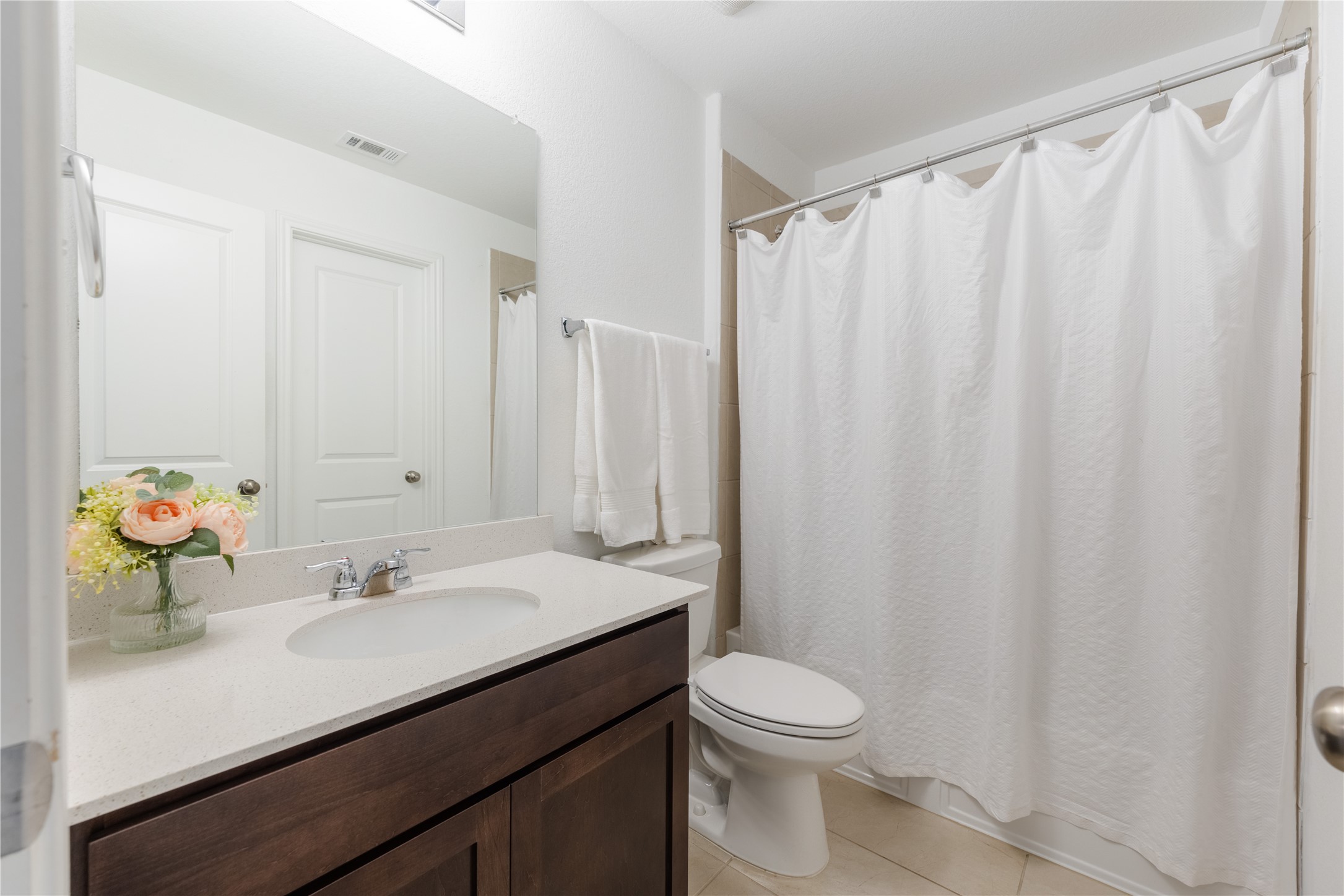 425 Perfect World Loop Jarrell, TX 76537 - Photo 20 of 29 Bathroom featuring a dark wood-finish vanity with a light countertop, a rectangular mirror, and chrome fixtures