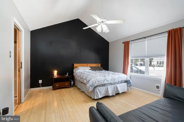 a bedroom with a bed and a large window with outer view