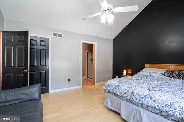 a bedroom with a large bed and a chandelier