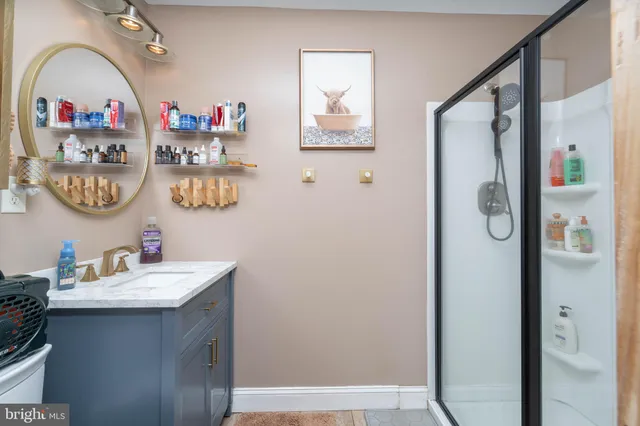 a bathroom with a sink mirror and a mirror