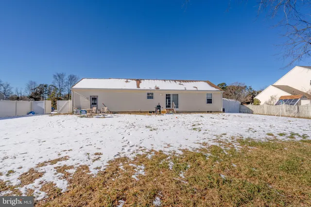 a view of white house with a yard