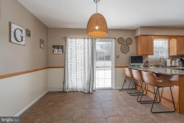 a view of a dining room with furniture and window