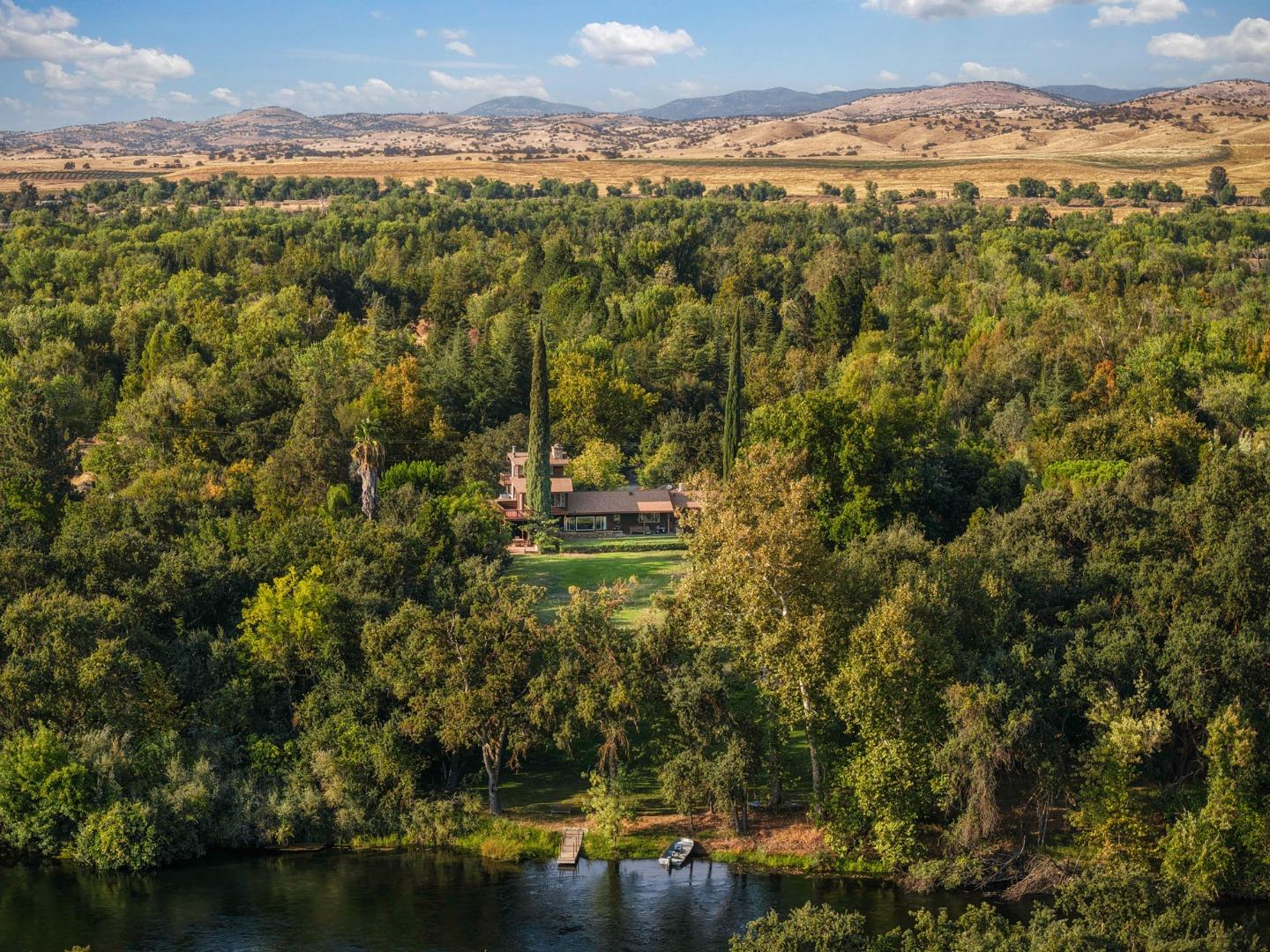 7555 Merced Falls Road Snelling, CA 95369 - Photo 28 of 77 a view of a lake with mountains in the background