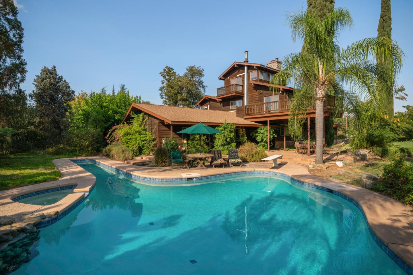 7555 Merced Falls Road Snelling, CA 95369 - Photo 3 of 77 a view of a house with swimming pool and porch with furniture