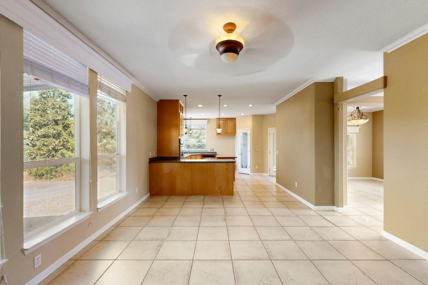 7555 Merced Falls Road Snelling, CA 95369 - Photo 46 of 77 a large white kitchen with a large window cabinets and stainless steel appliances