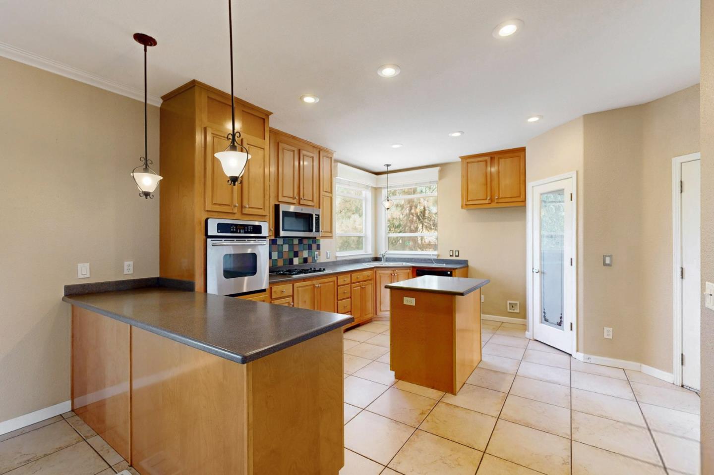 7555 Merced Falls Road Snelling, CA 95369 - Photo 47 of 77 a kitchen with stainless steel appliances granite countertop a sink a stove and a refrigerator