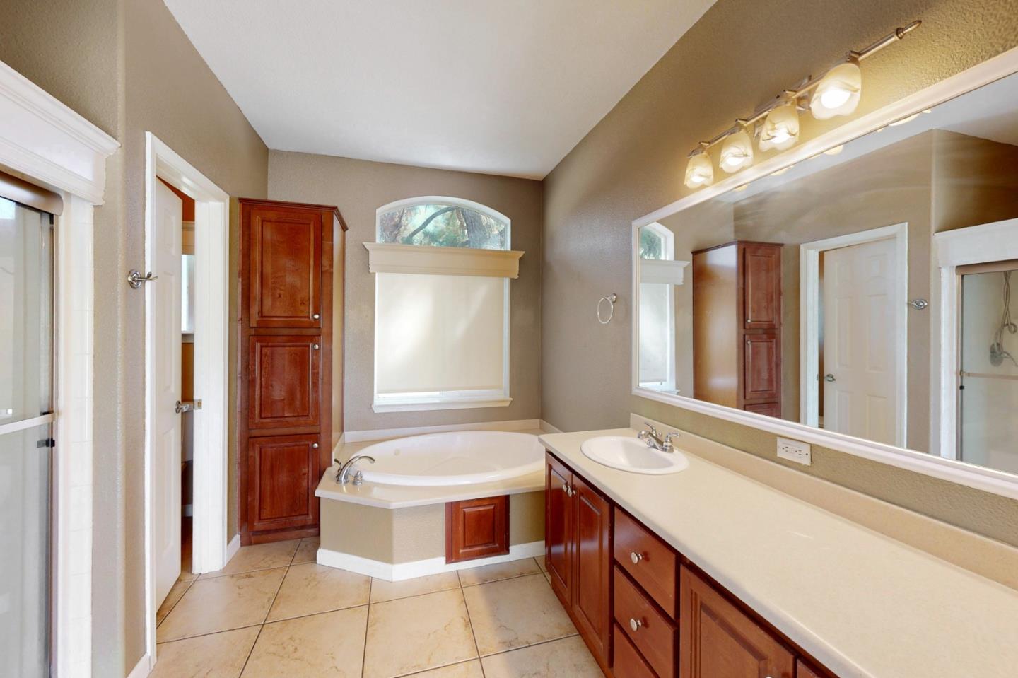 7555 Merced Falls Road Snelling, CA 95369 - Photo 56 of 77 a bathroom with a tub sink and a mirror
