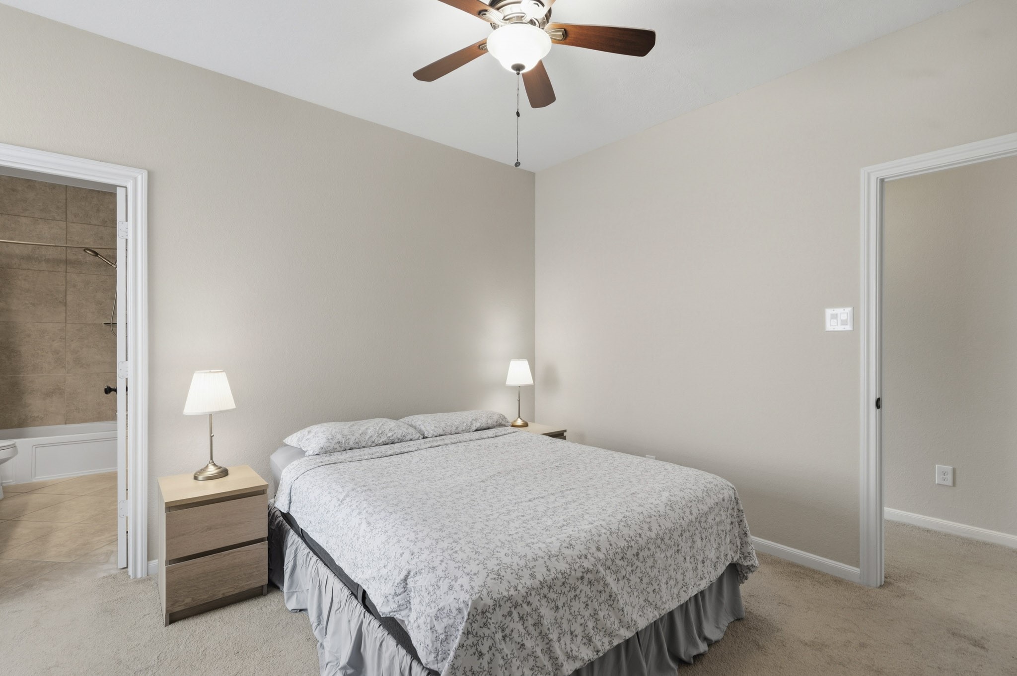 12115 San Luca Street Richmond, TX 77406 - Photo 28 of 44 Comfort meets style in this oversized secondary bedroom featuring large windows, and ample space for guests or family members to relax and unwind.